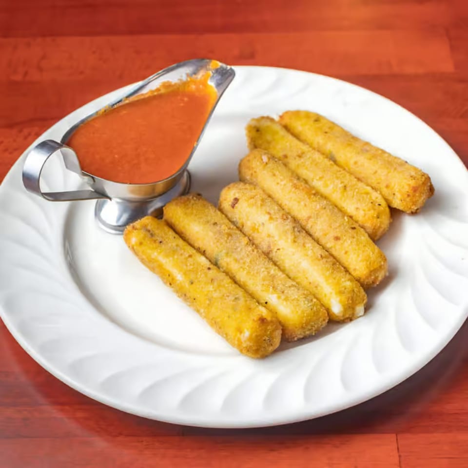 Golden-brown mozzarella sticks from Villa Formia, served with a side of red marinara sauce on a white plate.